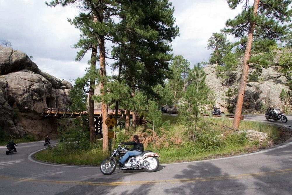Motorcyclists riding on the pigtail bridge and tunnel on US16A
